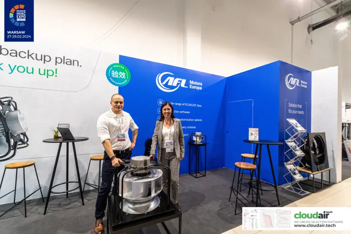 Two staff at AFL Motors Europe with a large centrifugal fan