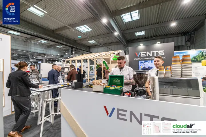 Vents coffee bar counter with espresso machine and branded back wall
