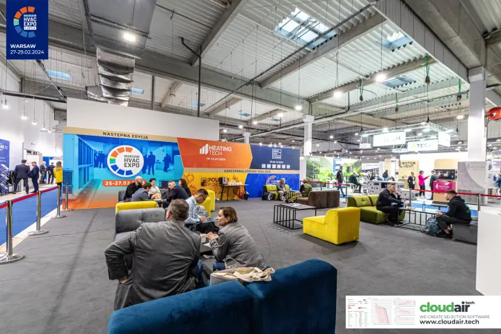 Visitor lounge in front of the organiser wall announcing the next edition