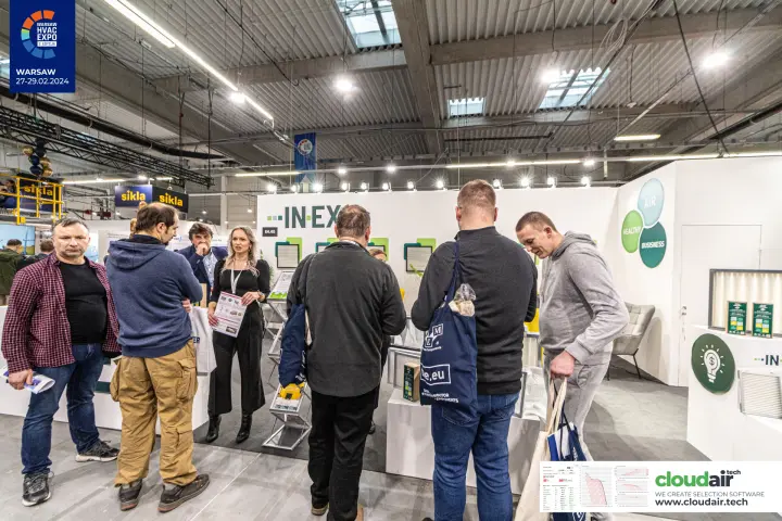 Visitors crowd the IN-EX air filter stand around staff with leaflets