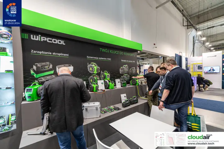 Visitors examining Wipcool vacuum pumps and condensate pumps at Warsaw HVAC Expo 2024