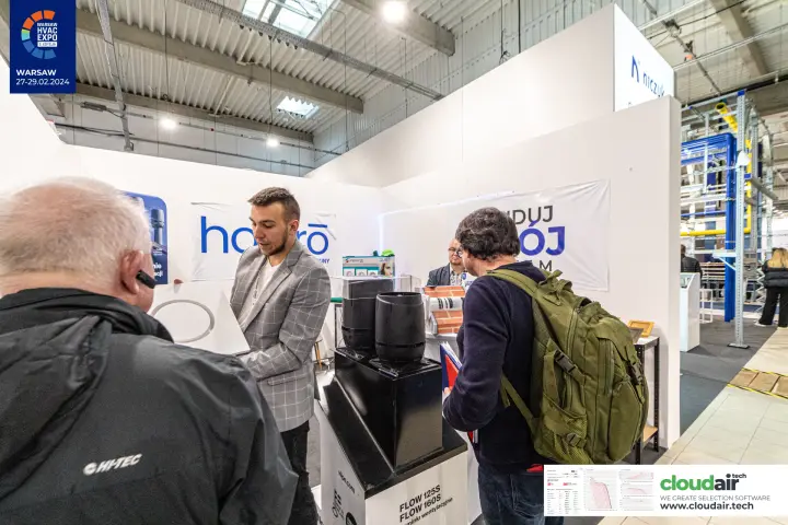 Visitors at the Hejero stand around black Vilpe Flow roof vents