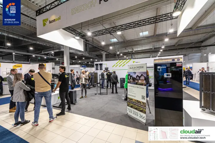 Visitors on the Kensol stand under its hanging white banner