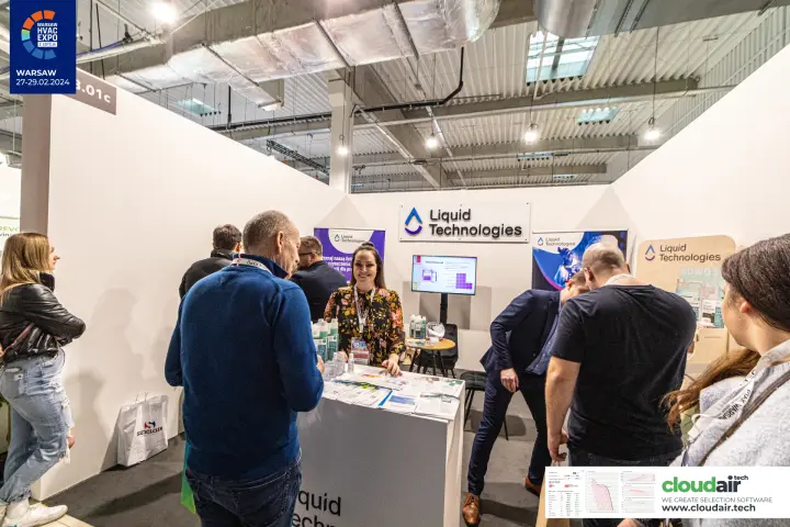 Visitors at the Liquid Technologies counter with cleaner leaflets at Warsaw HVAC Expo 2024