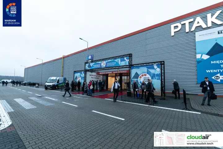 Wide view along the exhibition hall exterior toward the main entrance gate