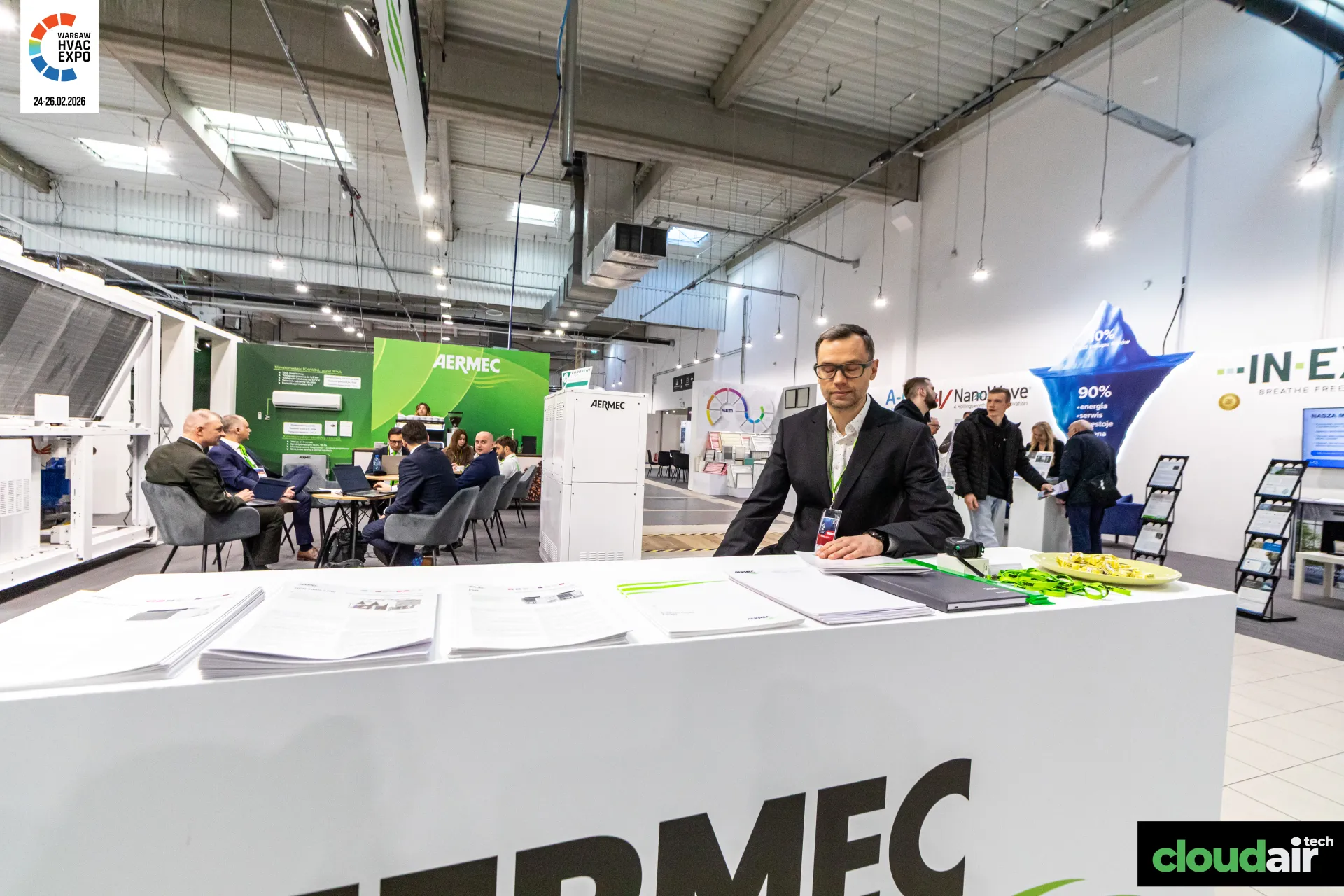 Aermec counter looking toward the meeting area and green display pavilion at Warsaw HVAC Expo 2026