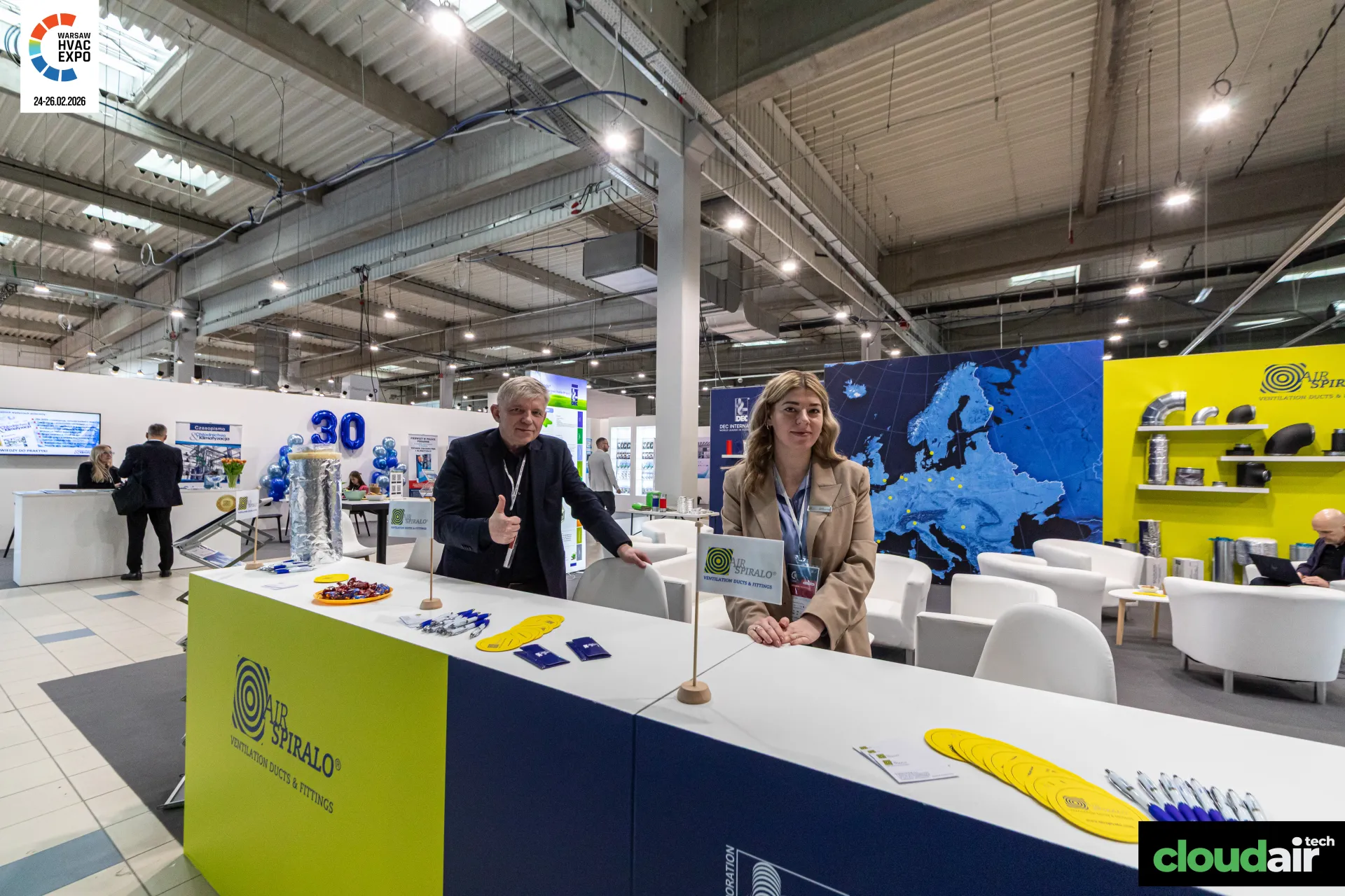 Air Spiralo counter with yellow wall of spiral ducts and fittings at Warsaw HVAC Expo 2026