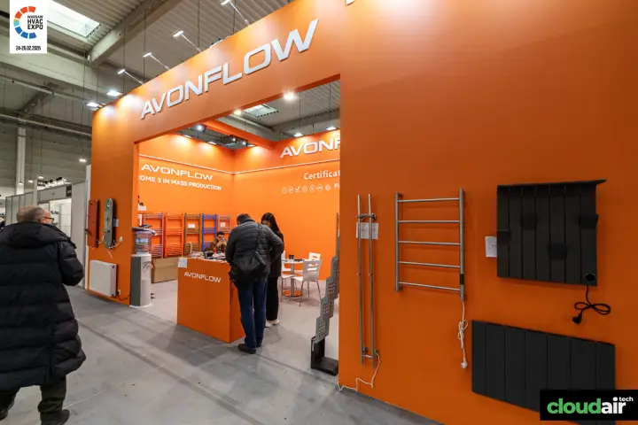 Avonflow stand with towel rails and electric radiators on an orange wall
