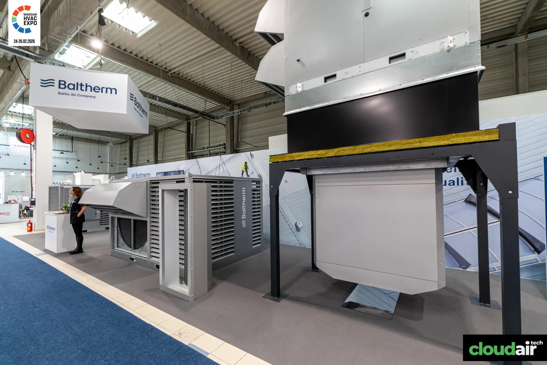 Baltherm unit raised on a steel roof-curb frame beside a louvred unit at Warsaw HVAC Expo 2026