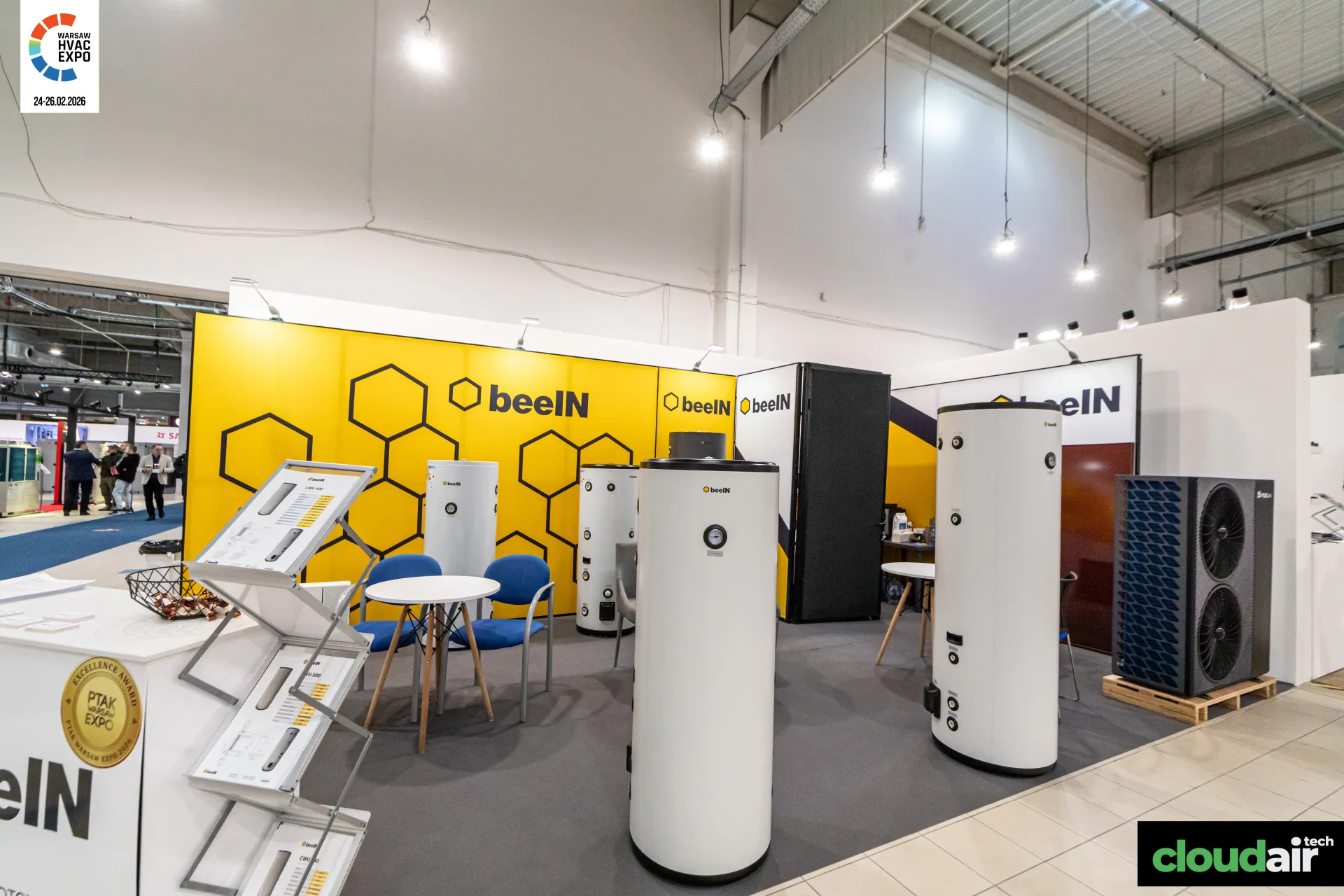 beeIN stand with hot water cylinders, a heat pump and yellow honeycomb walls at Warsaw HVAC Expo 2026