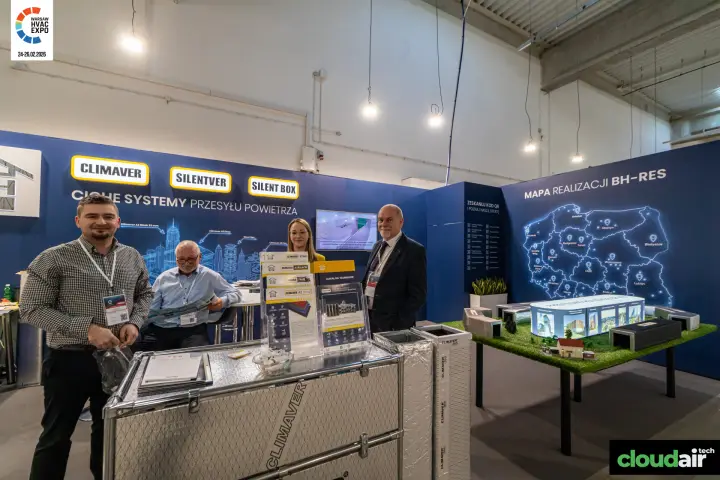 BH-Res team at a Climaver counter beside a building scale model