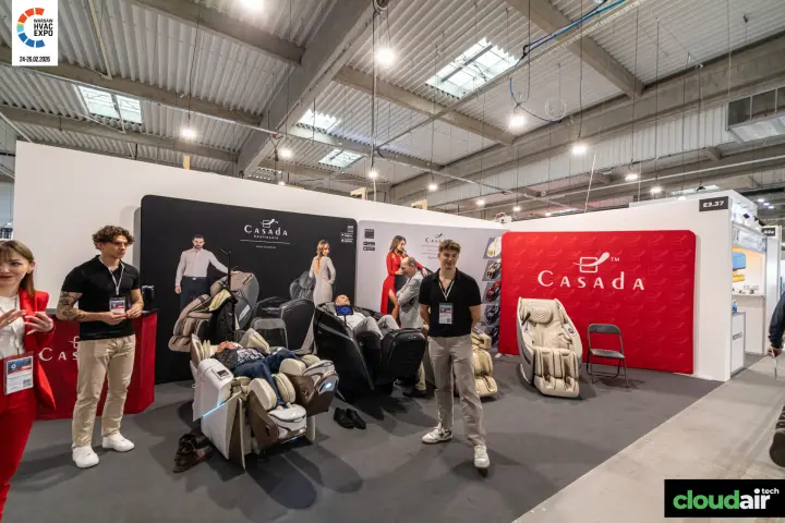 Casada stand with visitors trying out massage chairs at Warsaw HVAC Expo 2026