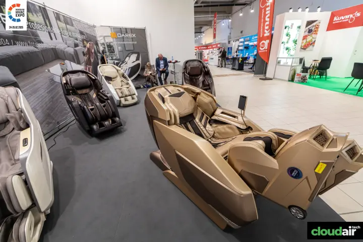 Gold Darex massage chair in front of further models along the banner wall at Warsaw HVAC Expo 2026