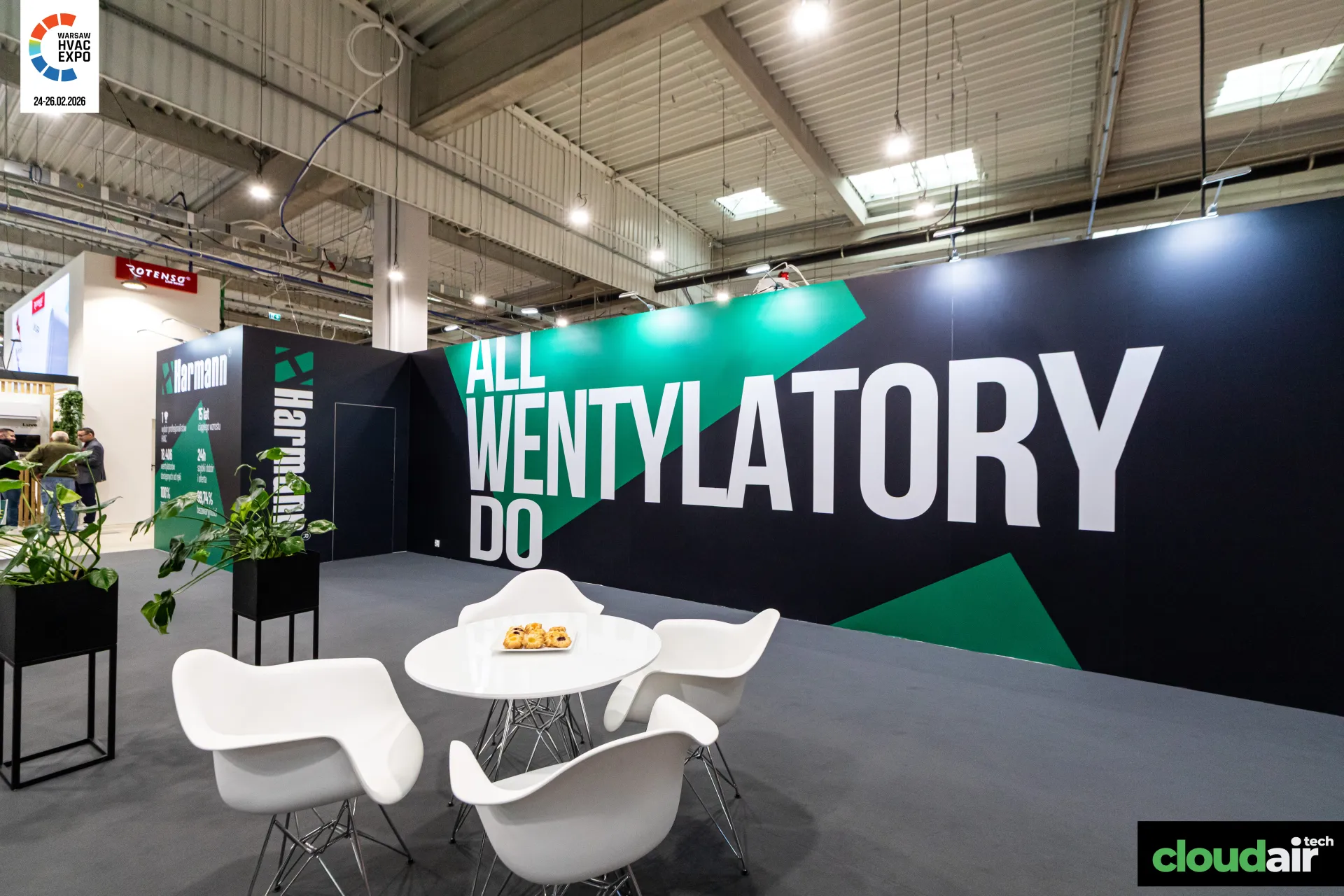 Harmann ALL WENTYLATORY DO slogan wall behind a white lounge set at Warsaw HVAC Expo 2026