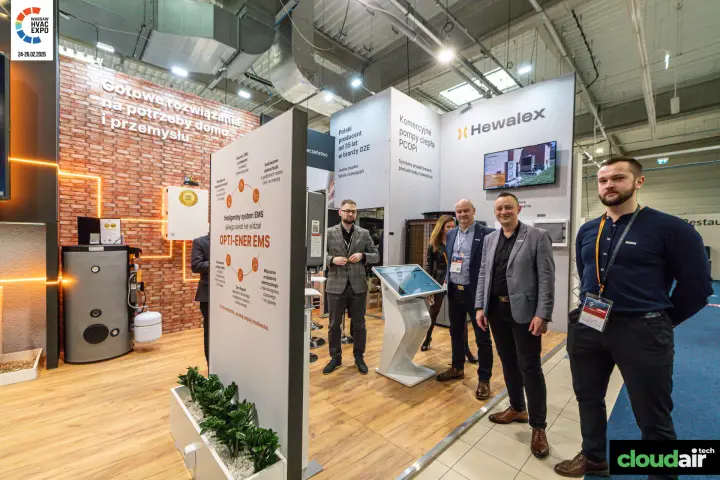 Hewalex team beside the OPTI-ENER EMS board and touchscreen kiosk at Warsaw HVAC Expo 2026