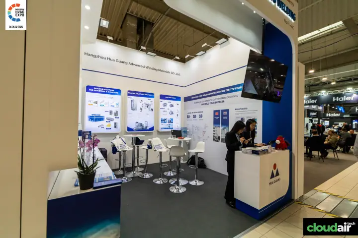 Hua Guang brazing materials stand with lightbox panels and bar seating at Warsaw HVAC Expo 2026