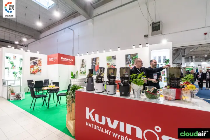 Kuvings slow juicer counter with fresh produce and red corner sign at Warsaw HVAC Expo 2026