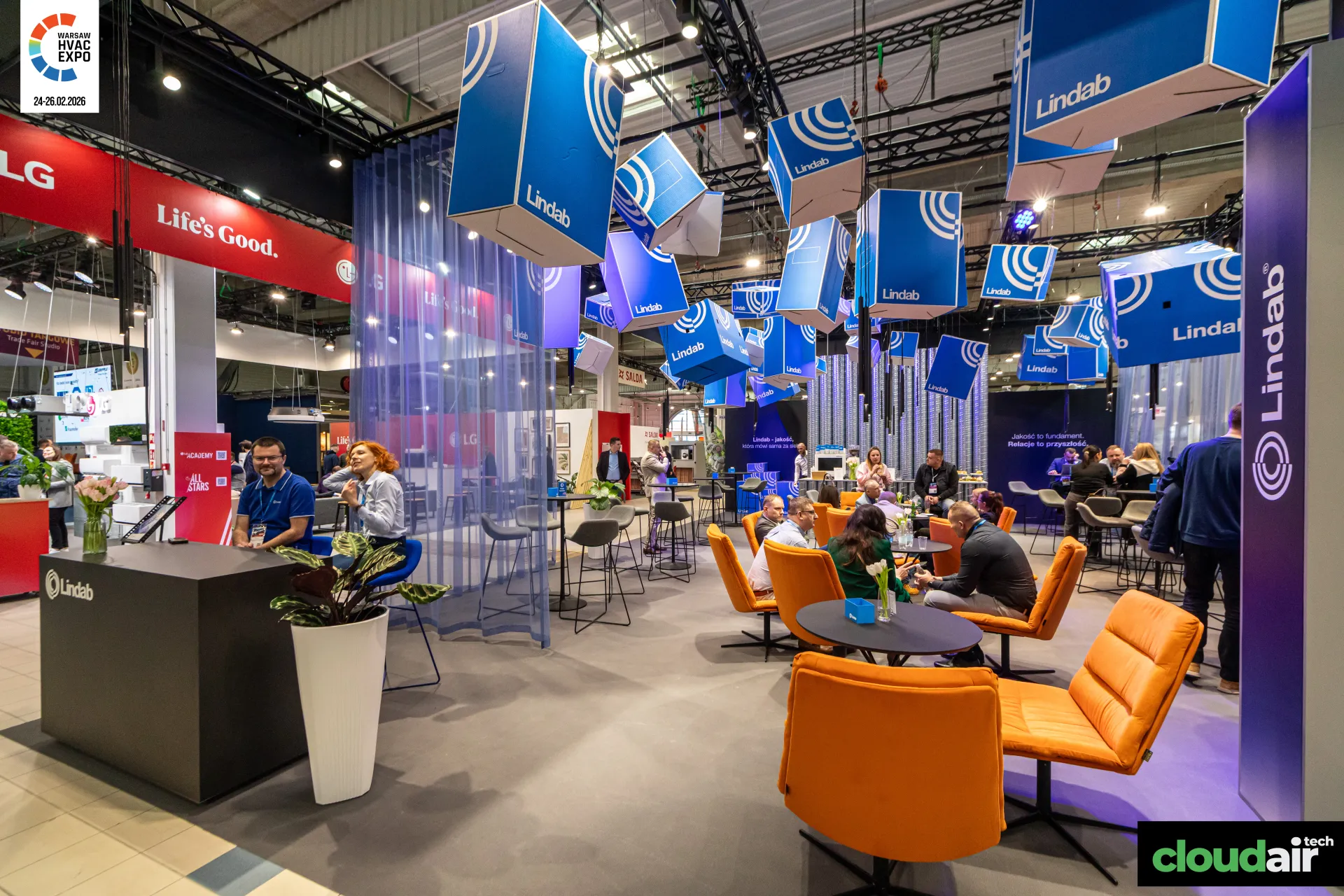 Lindab lounge with orange armchairs under hanging logo cubes at Warsaw HVAC Expo 2026