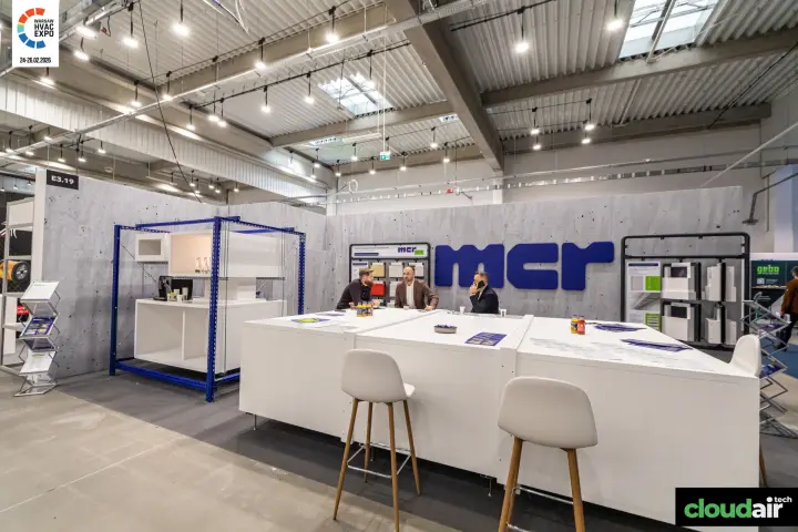 MCR stand with concrete-effect walls and long white meeting counter