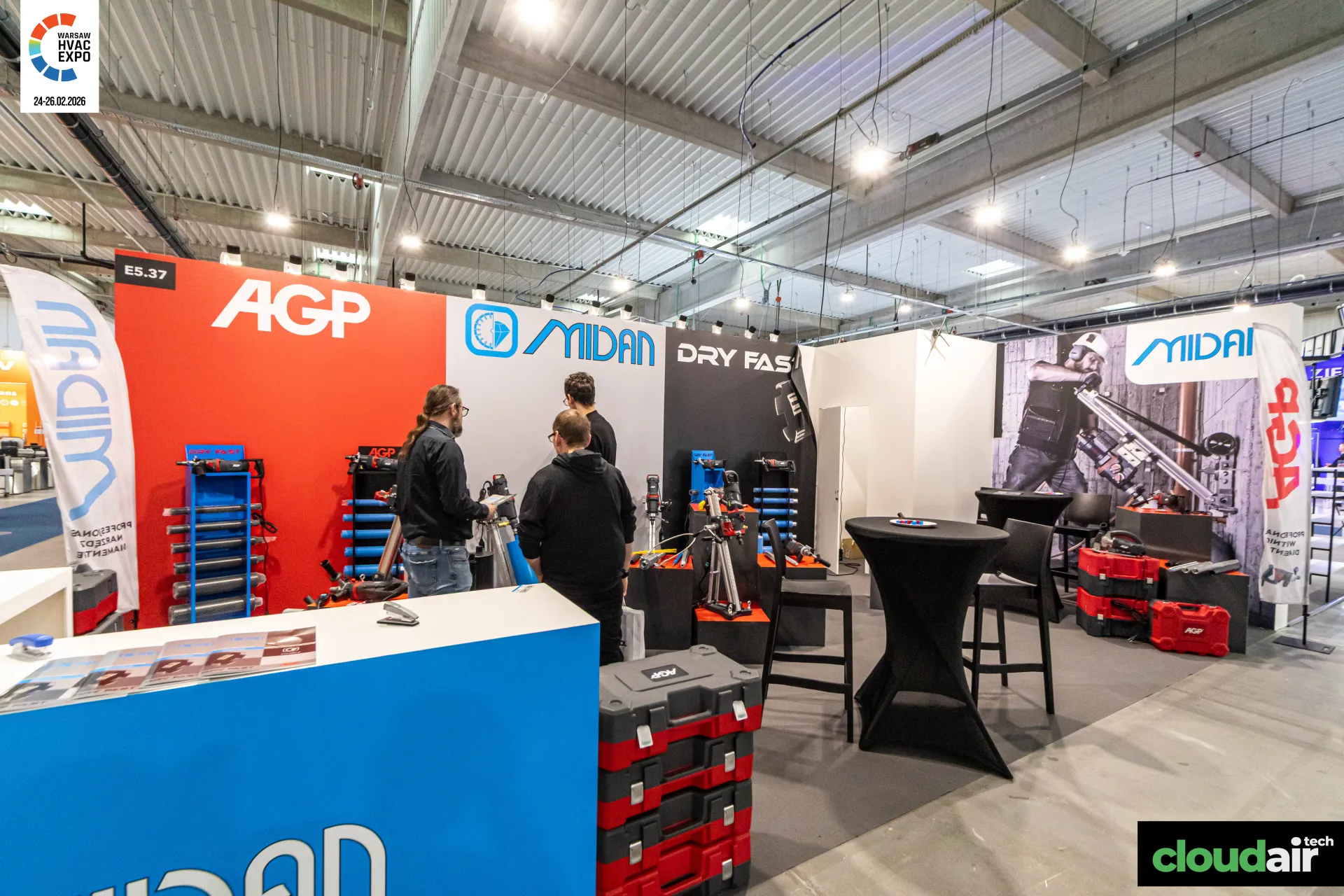 Midan and AGP stand with core drilling rigs and stacked red tool cases at Warsaw HVAC Expo 2026