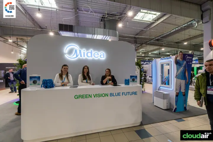 Midea reception counter with 'Green Vision Blue Future' slogan at Warsaw HVAC Expo 2026