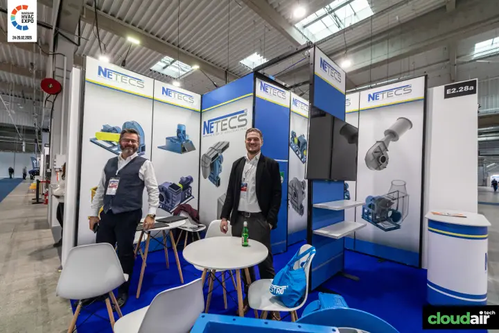 Netecs stand with fan graphics, round tables and a mounted display at Warsaw HVAC Expo 2026