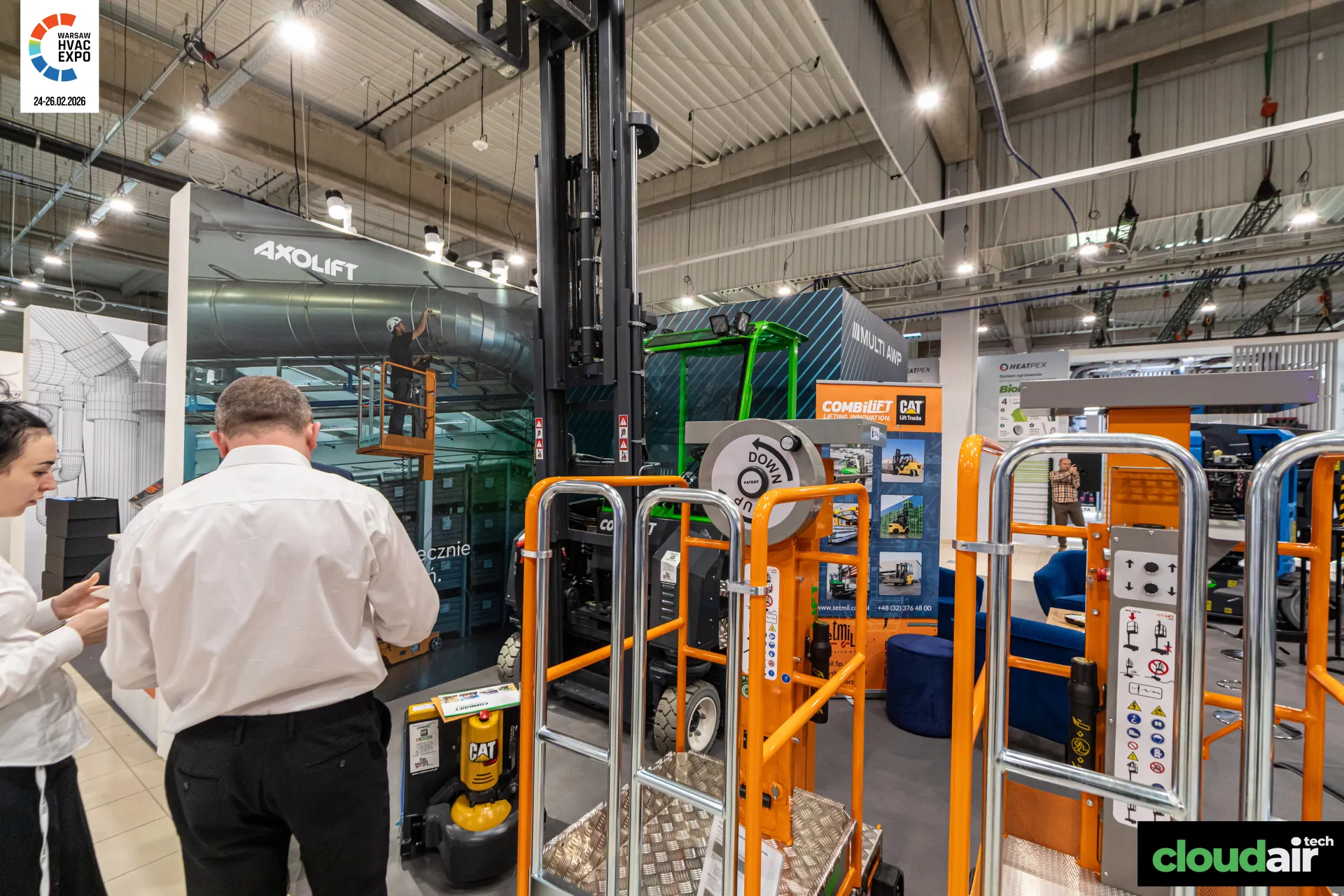 Orange personnel lifts and a Combilift forklift at the Multi AWP stand at Warsaw HVAC Expo 2026