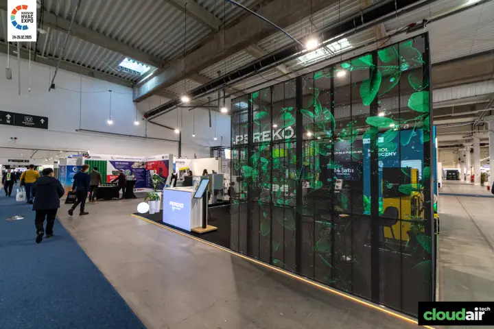Pereko stand behind a transparent LED mesh wall with green leaf graphics
