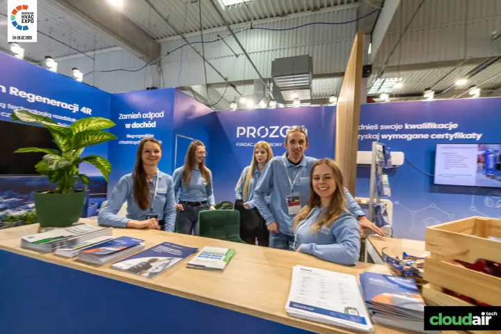 Prozon team behind the counter, with the certification wall and screen at Warsaw HVAC Expo 2026