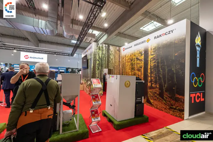Rakoczy firemax boiler and fuel hopper in front of forest graphics at Warsaw HVAC Expo 2026