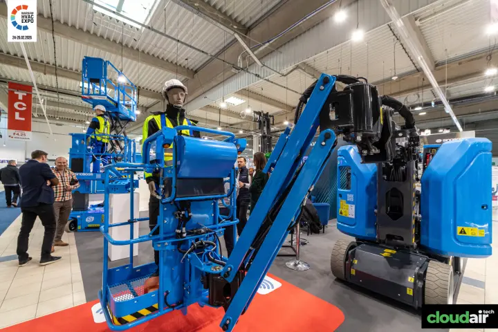 Sinoboom articulating boom lift with a mannequin operator in the basket at Warsaw HVAC Expo 2026