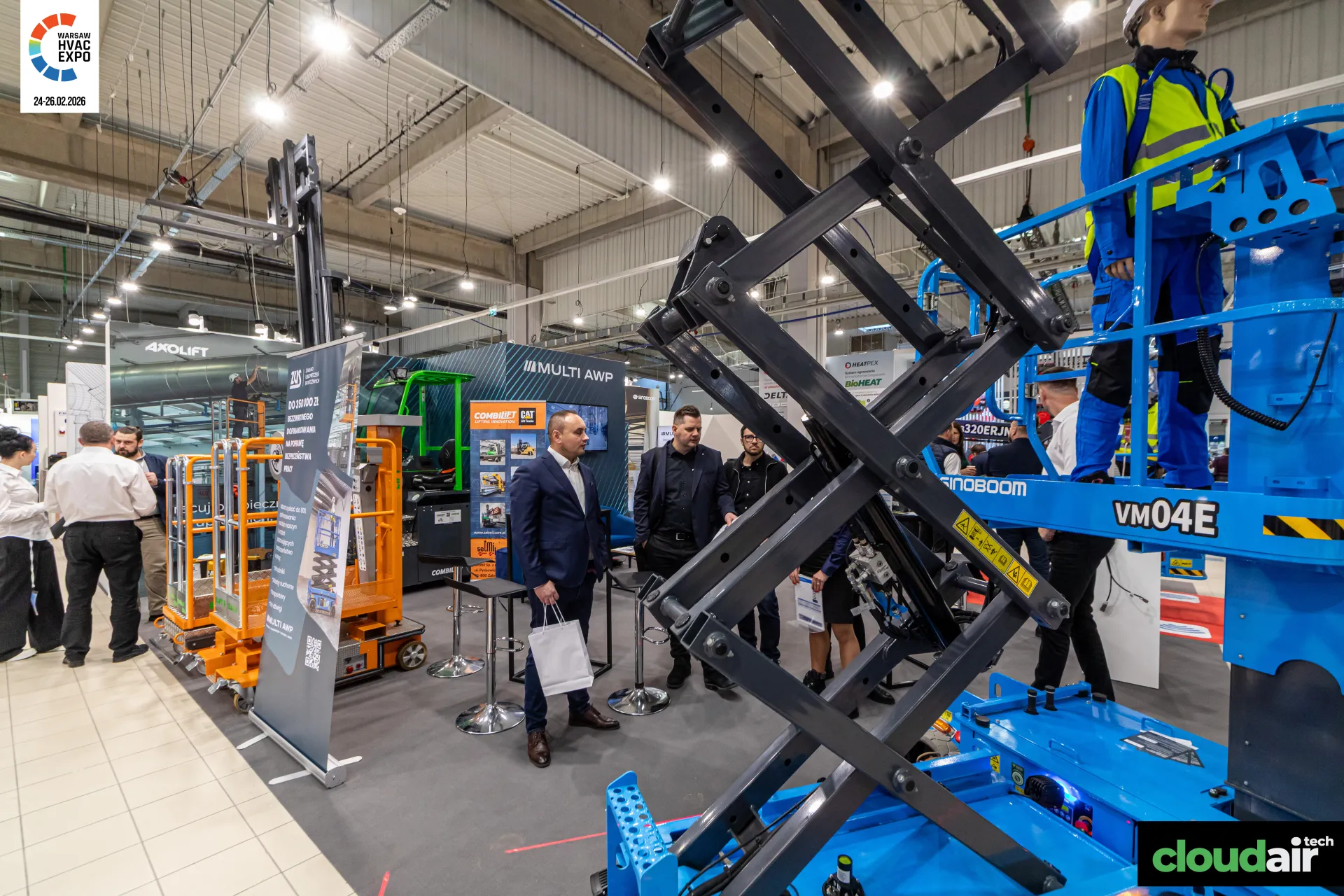 Sinoboom VM04E mast lift in front of the Multi AWP stand at Warsaw HVAC Expo 2026