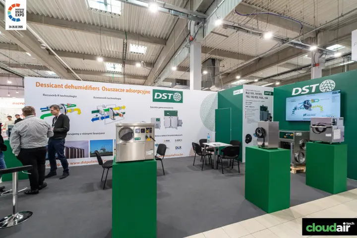 Stainless DST dehumidifiers on green plinths in front of rotor graphics at Warsaw HVAC Expo 2026