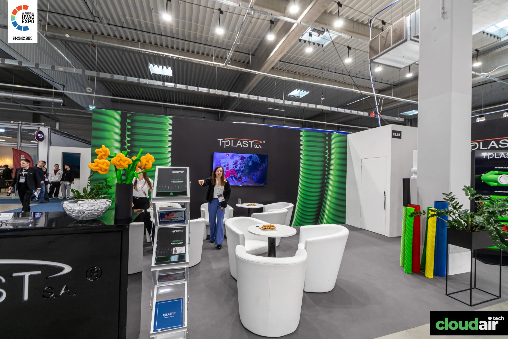 Tplast lounge with white armchairs and green corrugated pipe graphics at Warsaw HVAC Expo 2026