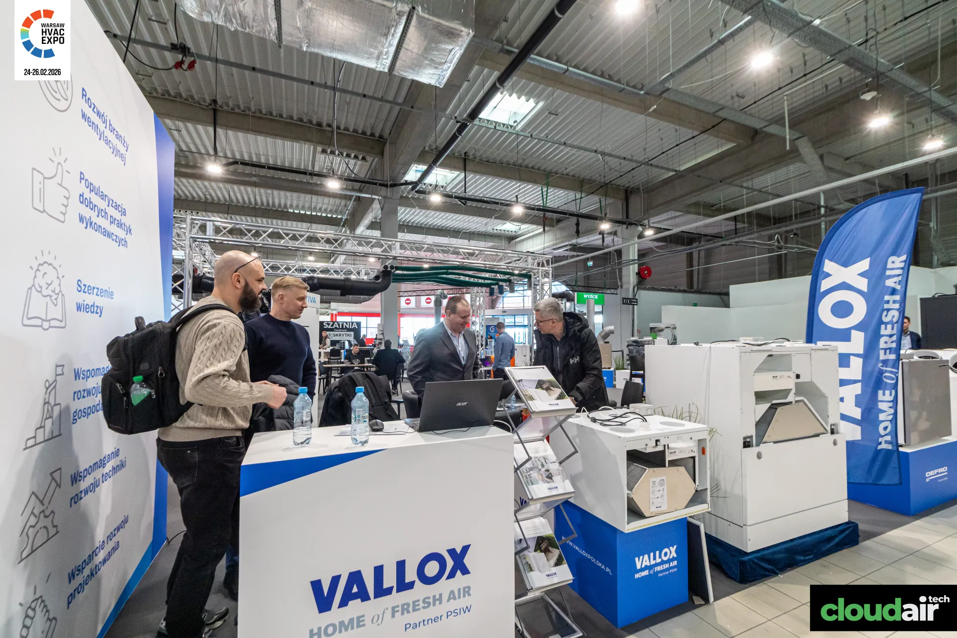 Vallox counter and feather flag beside the PSIW mission wall at Warsaw HVAC Expo 2026
