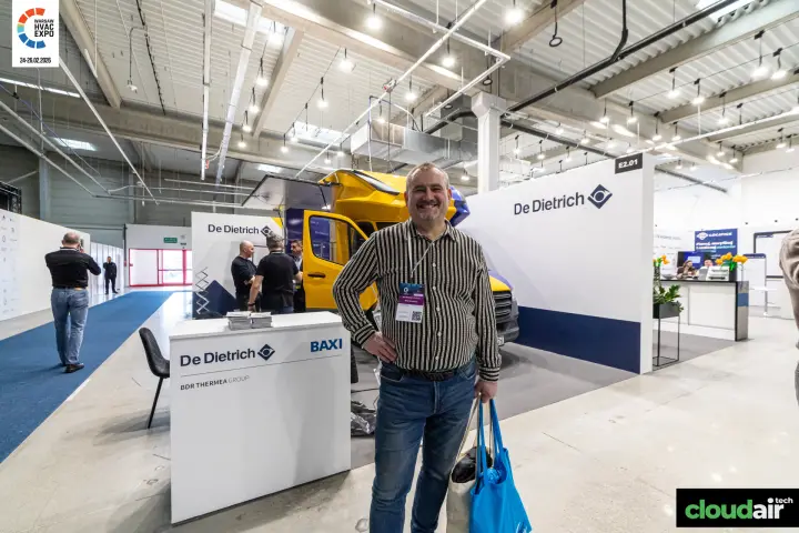 Visitor in front of the De Dietrich stand and its yellow showroom van