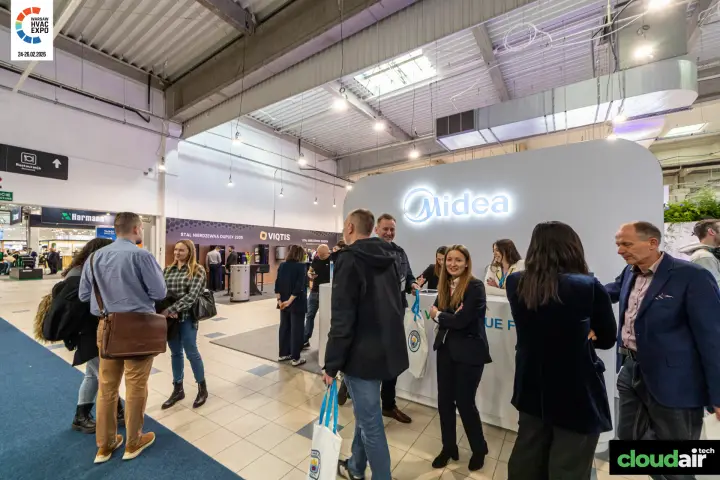 Visitors gathering at the Midea reception with backlit logo at Warsaw HVAC Expo 2026
