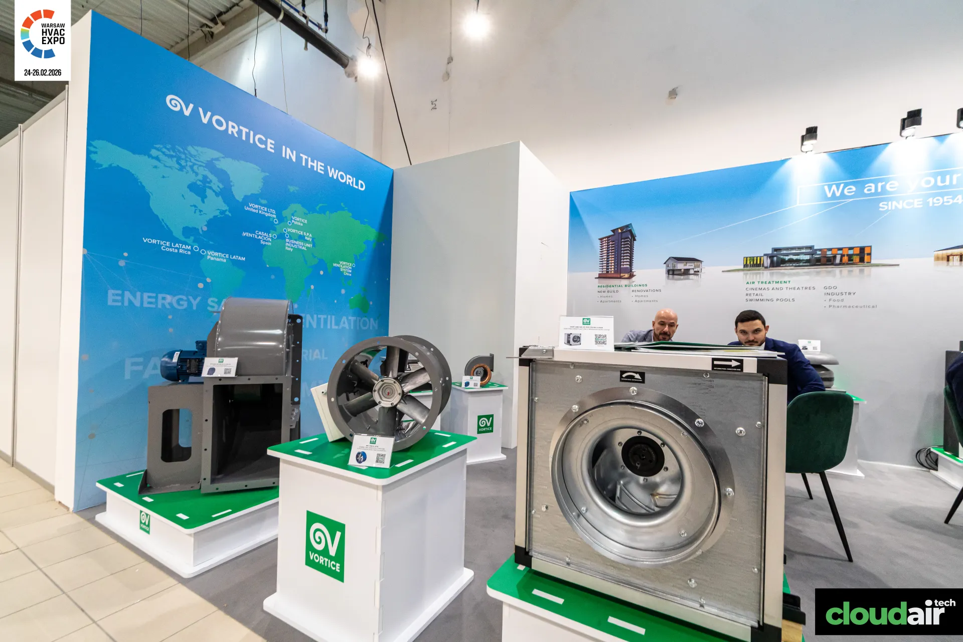 Vortice industrial fans on green-topped plinths beside a world map wall at Warsaw HVAC Expo 2026