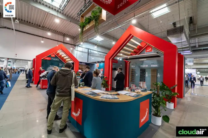 Zehnder stand with red house-shaped frames and a teal reception counter